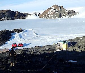 Looking down a hill towards the hut and Hagglunds on the plateau