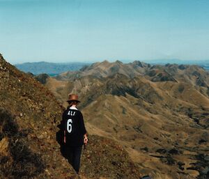A woman walks in mountains in New Zealand