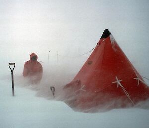 Person and tent alone in the Antarctic