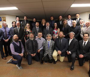 A smiling group of people in formal attire