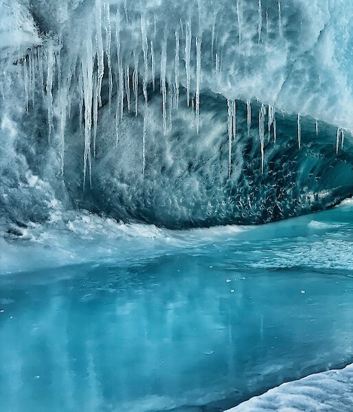 Ice cave with icicles on the roof.