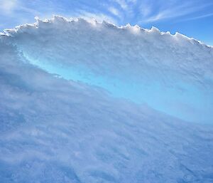 Ice wave cast against a blue sky