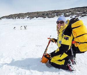 Expeditioner on ice watching penguins