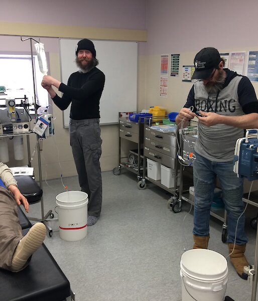 Two people confused with IV fluid bags