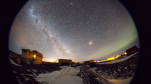fish eye lens shot of night sky with aurora and stars