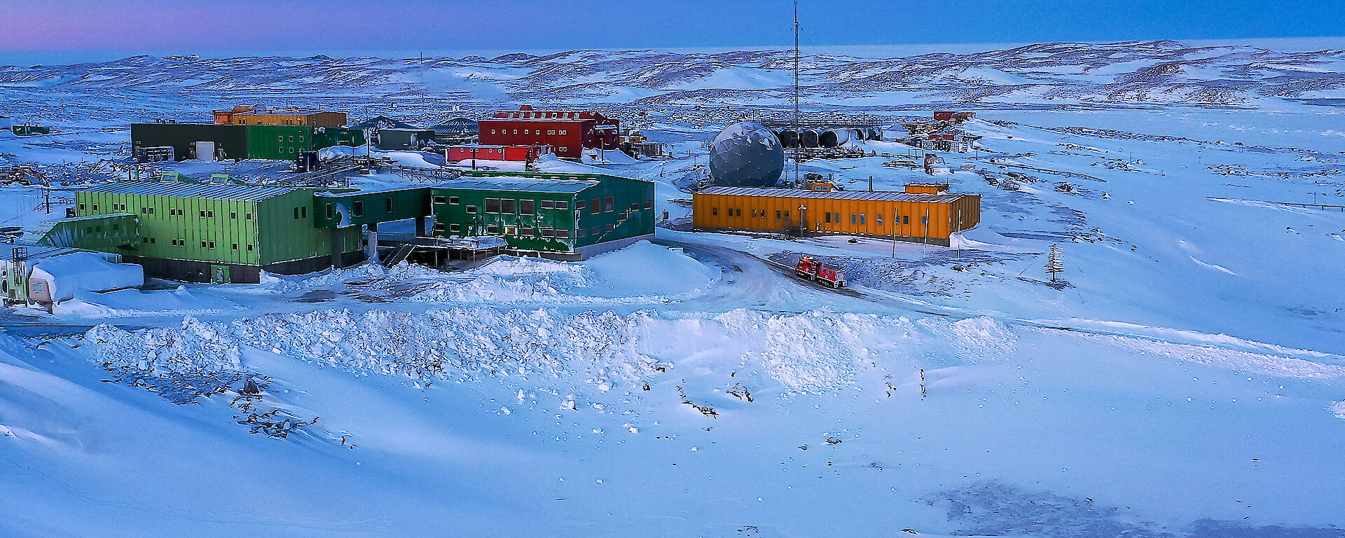 An aerial view of Davis Station showing a collection of building surrounded by ice