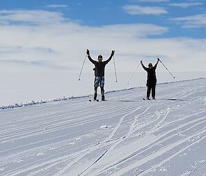 Two expeditioners cross-country skiing.