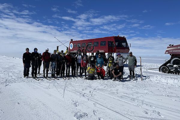 Group photo of expeditioners. Terrabus in the background.