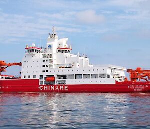 red and white ship on water