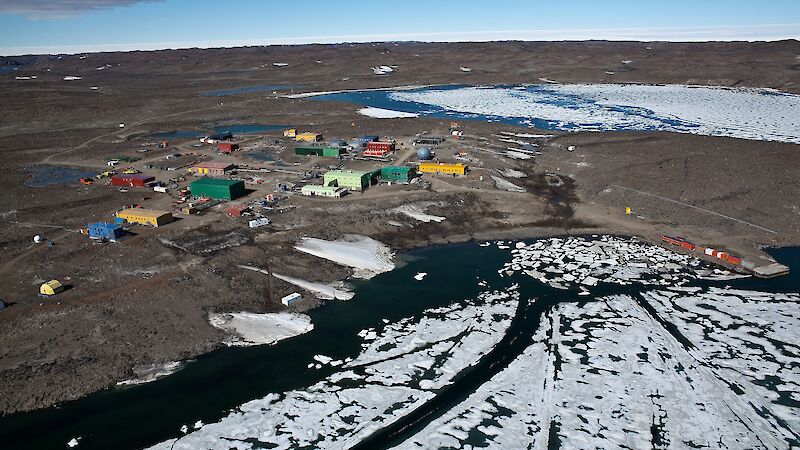 coloured buildings on rock, ice and water