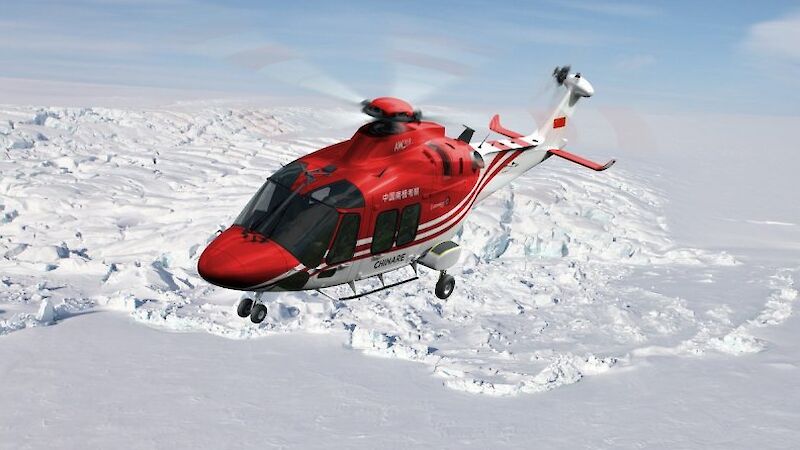 A red helicopter flying over a snow and ice covered landscape