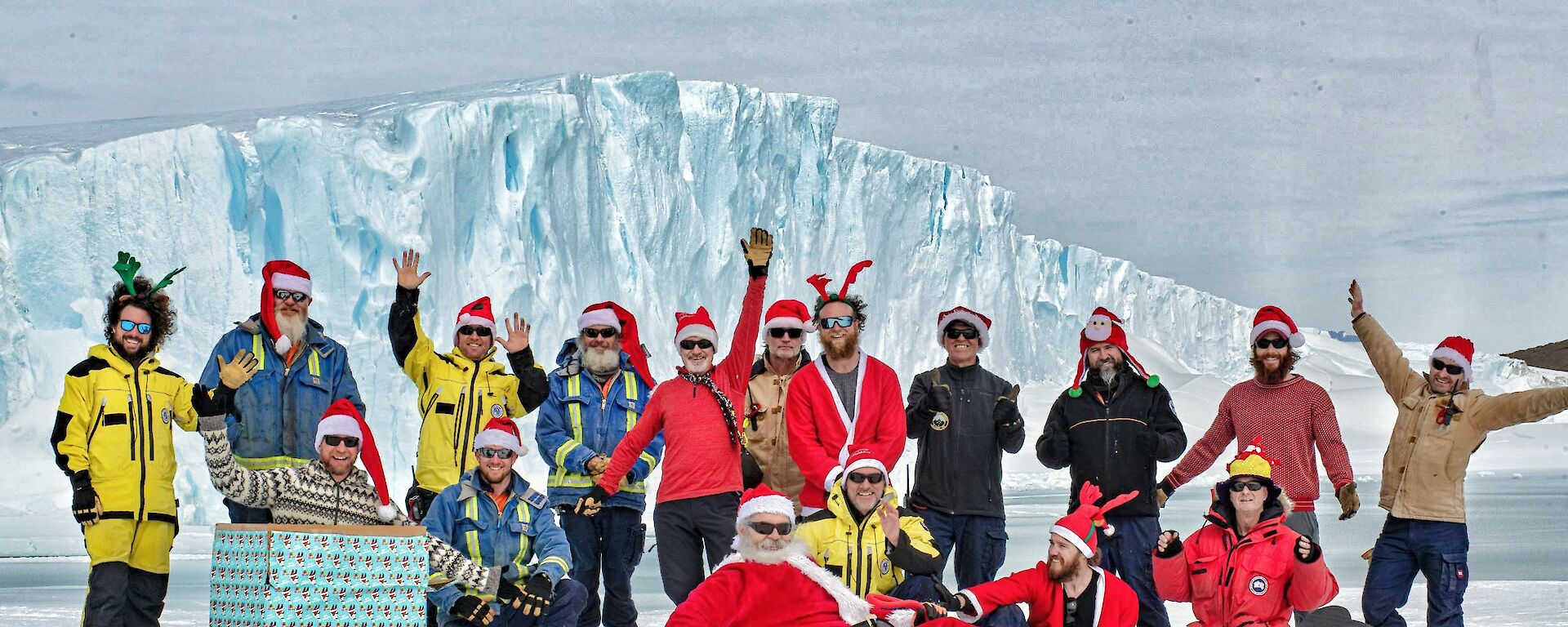 Expeditioners in christmas outfits and santa hats gathered on the ice to wish everyone merry Christmas