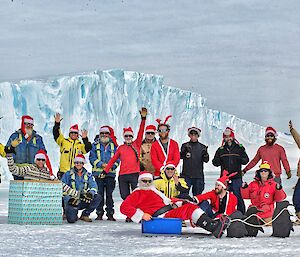 Expeditioners in christmas outfits and santa hats gathered on the ice to wish everyone merry Christmas