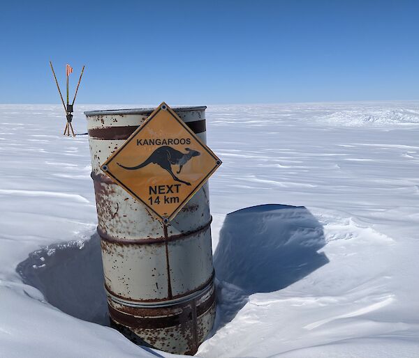 Humorous "Kangaroos next 14 km" sign in Antarctica. Surrounded by snow.