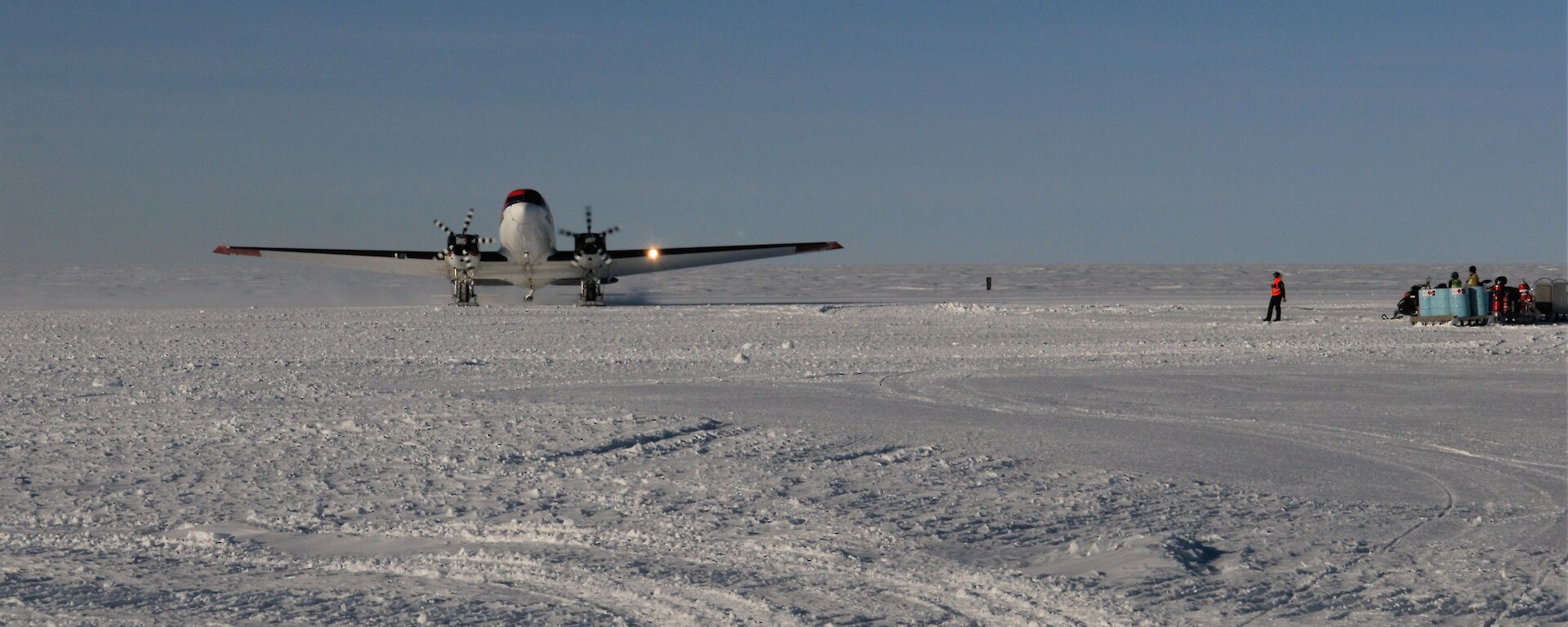 a plane lands on snow runway