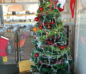 A christmas tree with a stack of presents underneath