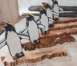 5 wooden penguin awards in a row