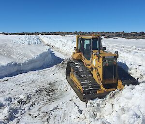 Bulldozer clearing a path in the snow