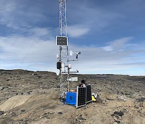 An AWS tower on a rocky landscape