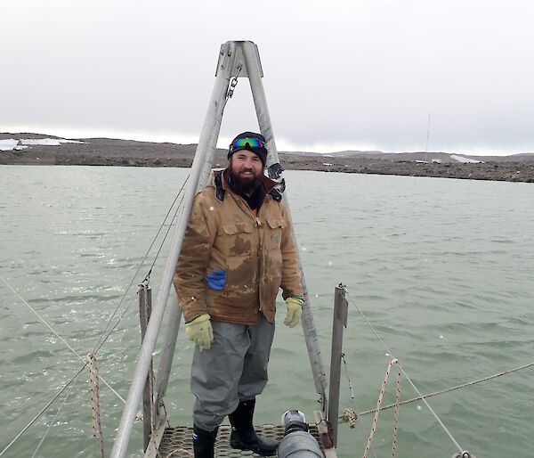 An expeditioner standing at the end of the pontoon looking at the camera
