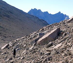 Looking between a rocky valley towards a craggy mounting in the distance