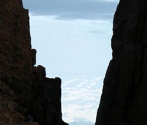 Looking between two large mountains to the icy landscape beyond