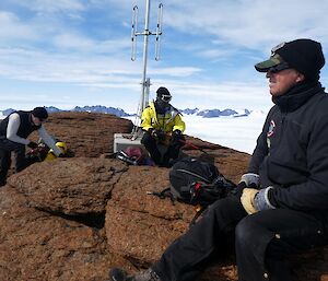 The expeditioners take a rest at the top of a mountain