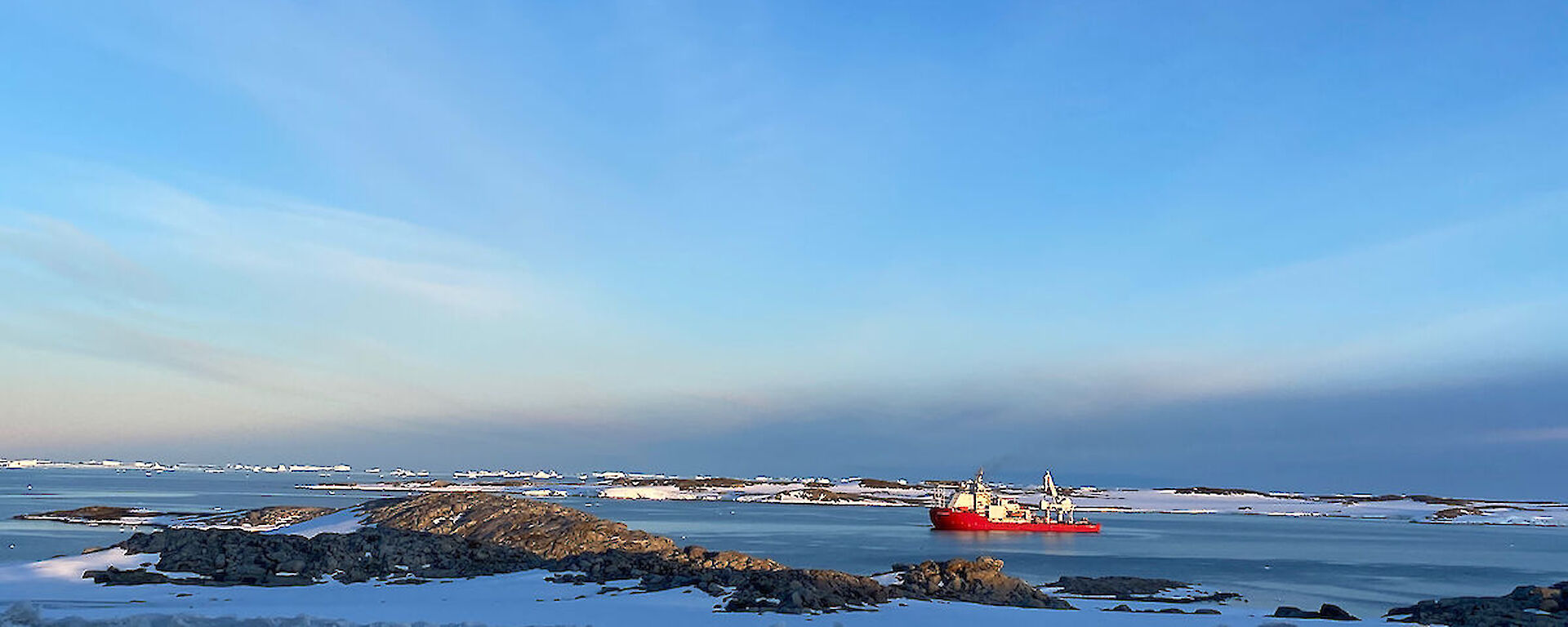 ship offshore from Antarctica surrounded by sea ice