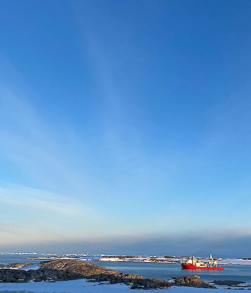 ship offshore from Antarctica surrounded by sea ice