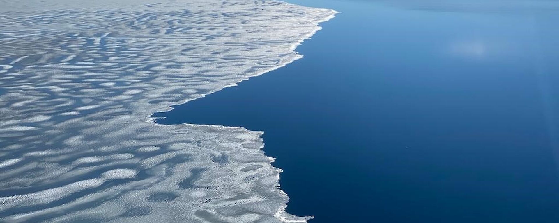 A view of the bay.  Half the water is covered in semi melted ice and the other is ice free