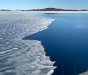 A view of the bay.  Half the water is covered in semi melted ice and the other is ice free