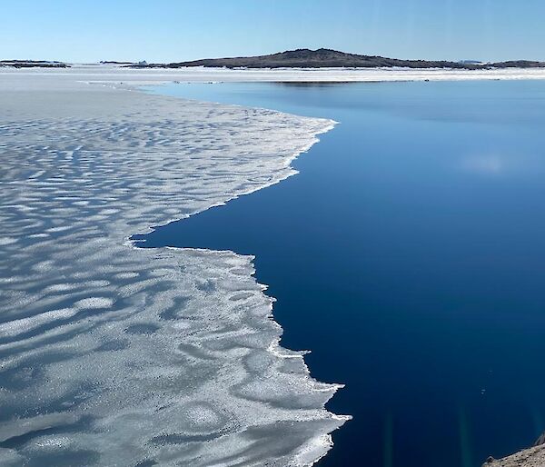 A view of the bay. Half the water is covered in semi melted ice and the other is ice free