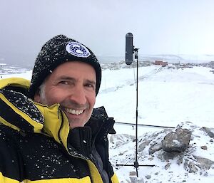 man with microphone in snowy landscape