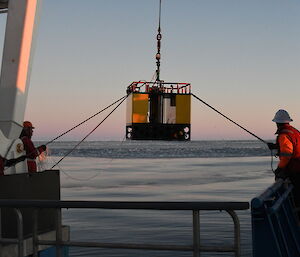 Camera and echosounder called KOMBI is lowered into ocean