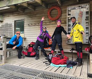 Four expeditioners pose outside the office