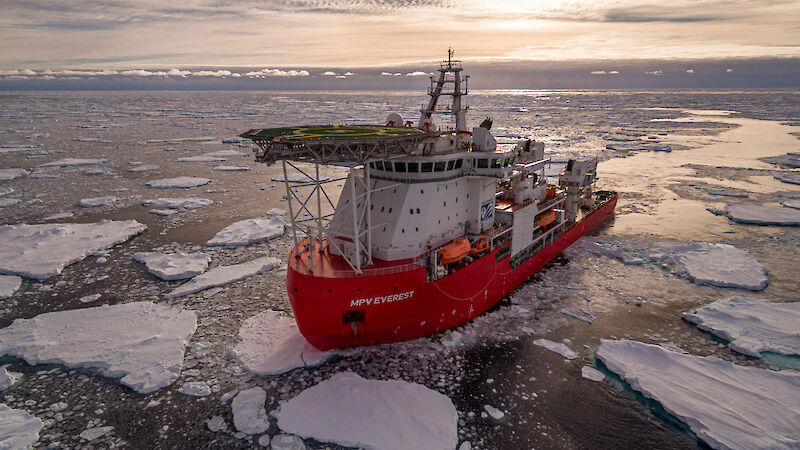 Everest in the ice with the sun low in the sky behind