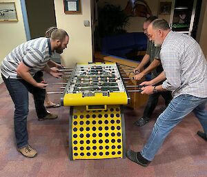 Expeditioners playing Foosball