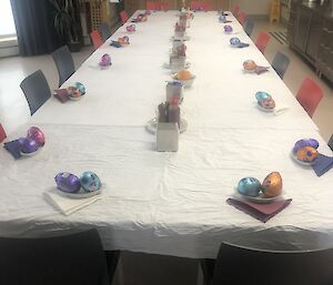 Table set for 18 expeditioners with Easter eggs