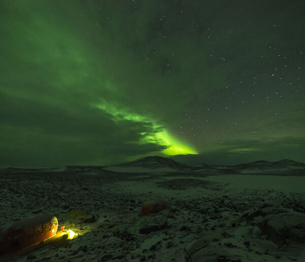 Field tent lit up at night