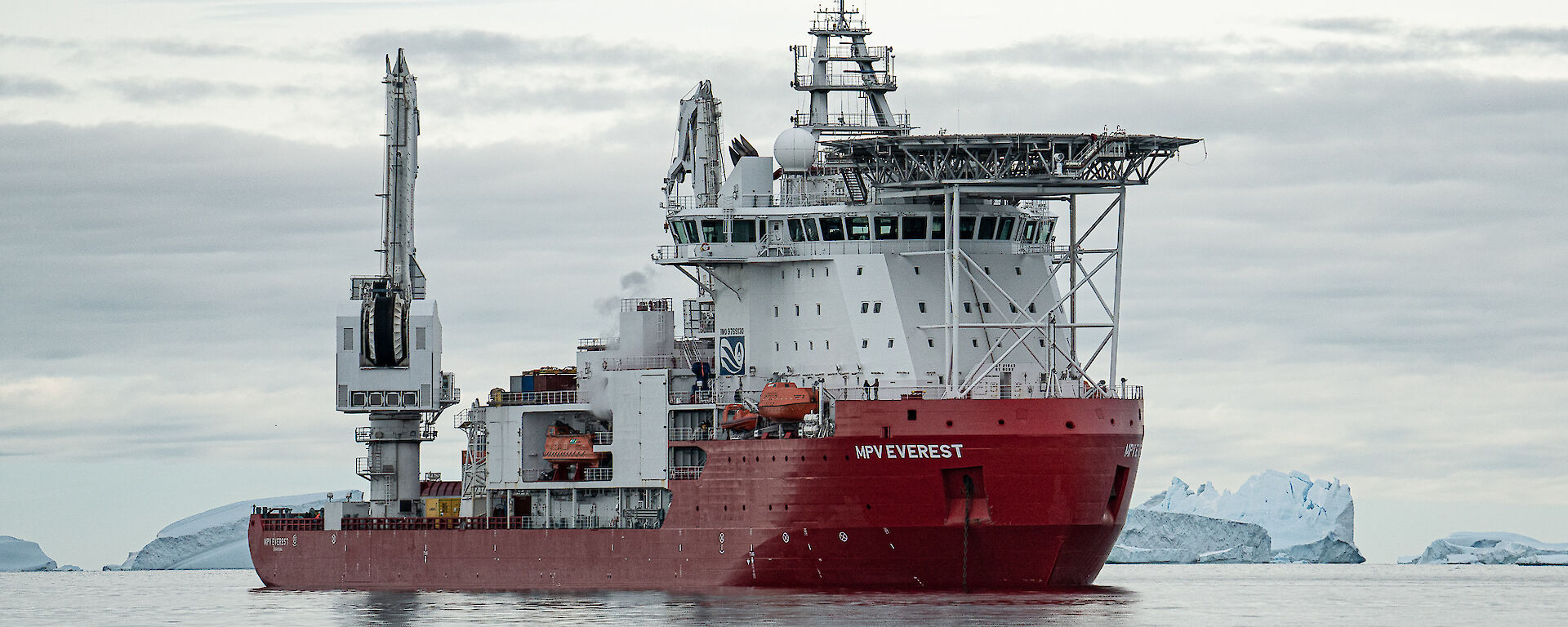 Resupply ship with icebergs  in background