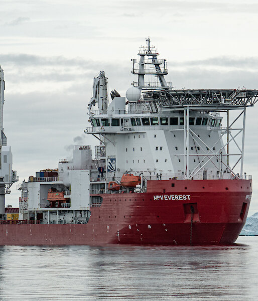 Resupply ship with icebergs  in background