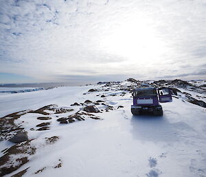 Two Hagglunds travelling across snow covered peninsula