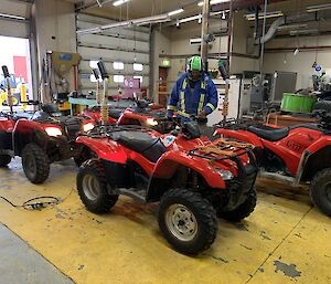 4 quad bikes in a workshop