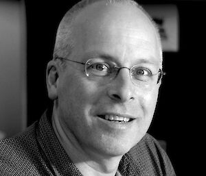 Photographic portrait of white man with glasses.