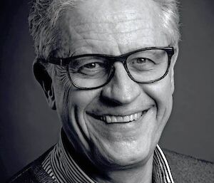 Photographic portrait of white man with glasses.