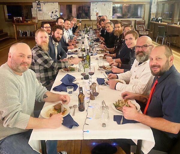 A group of people around a long dining table.