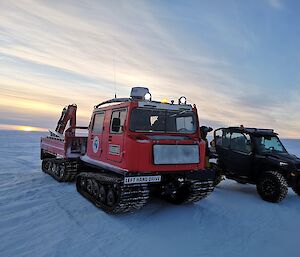 a Hagglunds and Polaris General vehicle parked in the snow