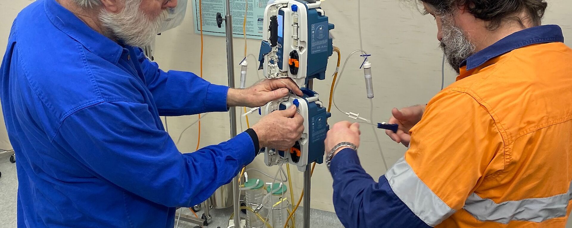 2 men working an IV station
