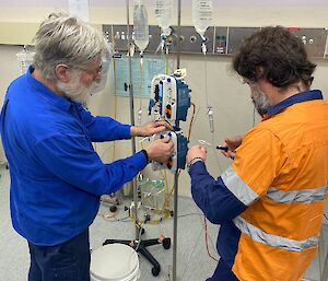 2 men working an IV station