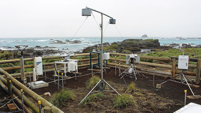 Atmospheric instruments inside a wooden fence on Macquarie Island.